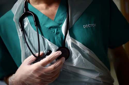 A Junior Doctor holds his stethoscope during a patient visit on Ward C22 at The Royal Blackburn Teaching Hospital in East Lancashire, during the current coronavirus disease (COVID-19) epidemic, on May 14, 2020 in Blackburn, England.
