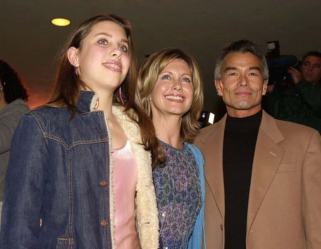 Olivia Newton John, center, daughter Chloe, left, and boyfriend Patrick McDermott, right, arrive at the Los Angeles opening of