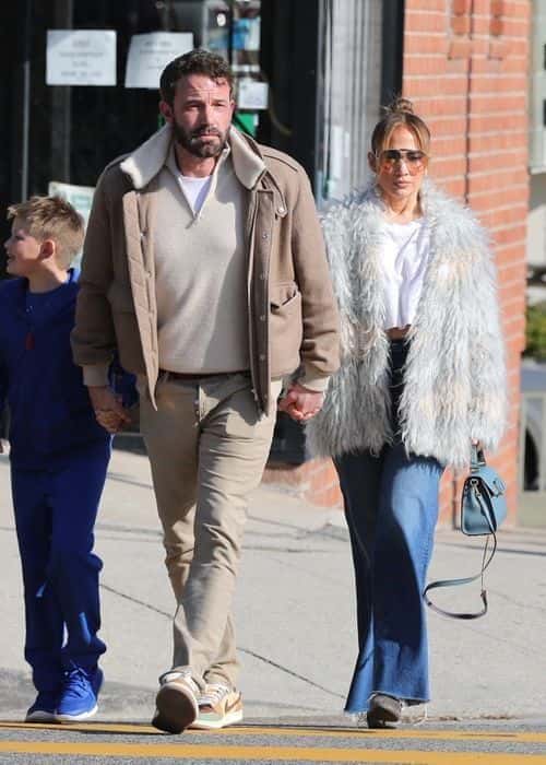 The pair were snapped holding hands with each other as they crossed the road (Backgrid)