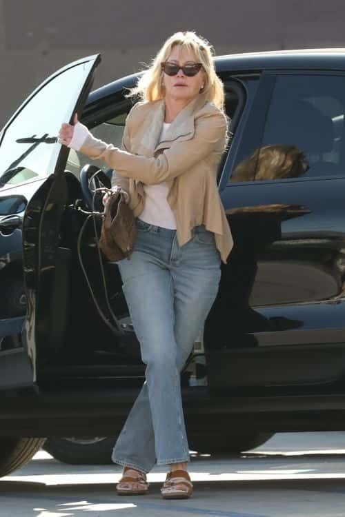 Melanie Griffith donned a cream leather jacket over a white tee, which she paired with light blue jeans and brown sandals (Backgrid)