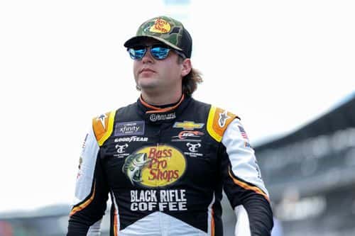 Noah Gragson, driver of the #9 Bass Pro Shops/TrueTimber/BRCC Chevrolet, walks the grid during practice for the NASCAR Xfinity Series Pennzoil 150 at the Brickyard at Indianapolis Motor Speedway on July 29, 2022 in Indianapolis, Indiana.