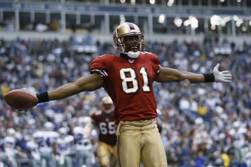 Wide receiver Terrell Owens #81 of the San Francisco 49ers celebrates in the end zone after scoring a touchdown against the Dallas Cowboys with 12 seconds left on December 8, 2002 at Texas Stadium in Irving, Texas.  The 49ers beat the Cowboys 31-27.