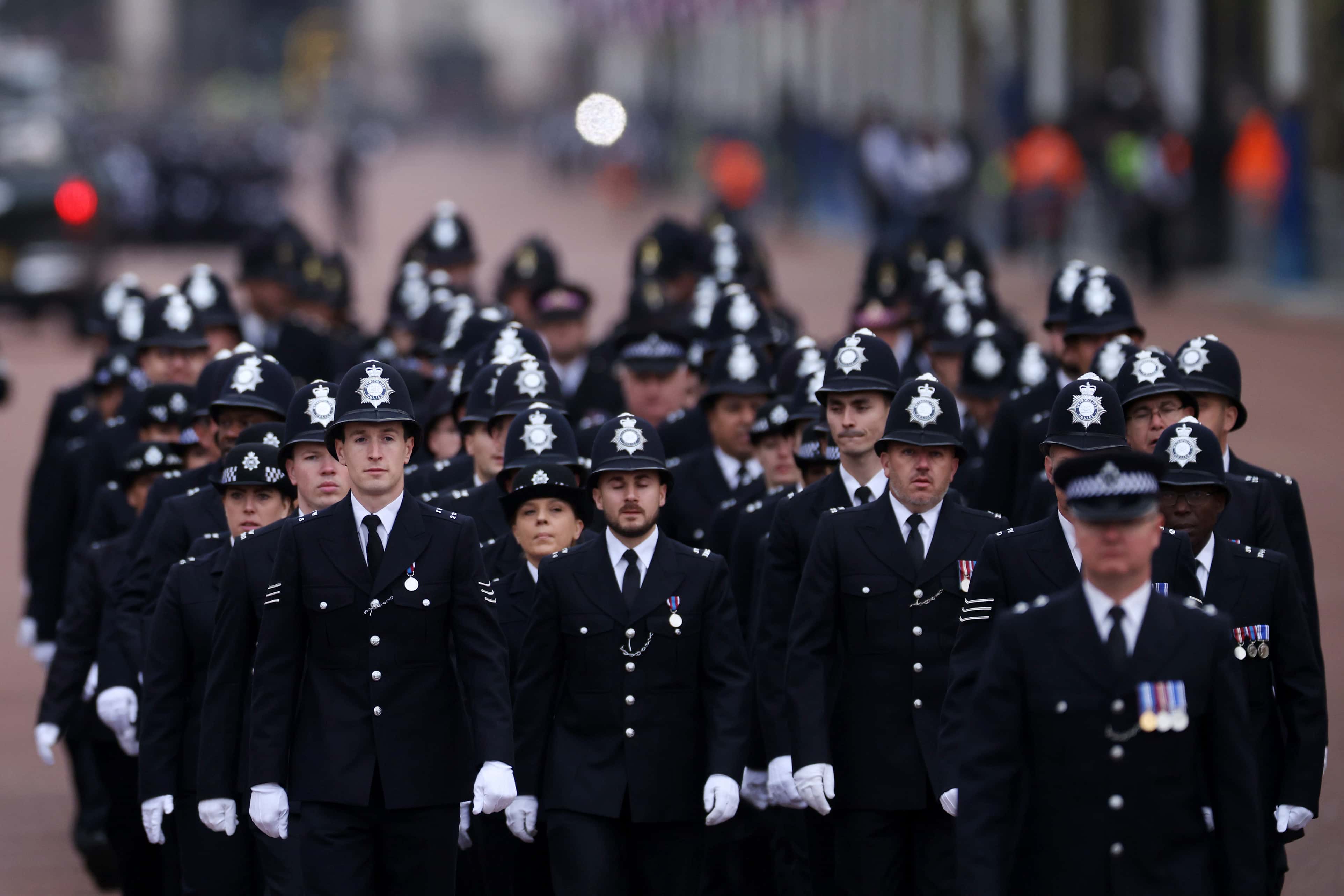 Metropolitan Police Officers are seen walking in formation down The Mall ahead of the State Funeral Of Queen Elizabeth II on September 19, 2022 in London, England.  Elizabeth Alexandra Mary Windsor was born in Bruton Street, Mayfair, London on 21 April 1926. She married Prince Philip in 1947 and ascended the throne of the United Kingdom and Commonwealth on 6 February 1952 after the death of her Father, King George VI. Queen Elizabeth II died at Balmoral Castle in Scotland on September 8, 2022, and is succeeded by her eldest son, King Charles III.