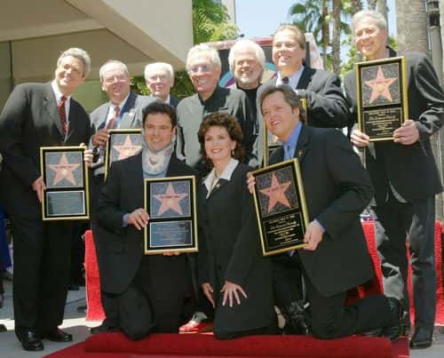 (L-R standing)  Jay, Tom, family patriarch George, singer Andy Williams, Merrill, Allan and Wayne Osmond.  Seated are Donny, Marie and Jimmy Osmond posing at a ceremony honoring The Osmond family with a star on the Hollywood Walk of Fame August 7, 2003 in Hollywood, California. Donny injured his neck while body surfing in Hawaii.
