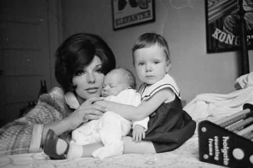 Film star Joan Collins, wife of actor and singer Anthony Newley, with her daughter Tara aged two and six week old Alexander, Sasha for short.