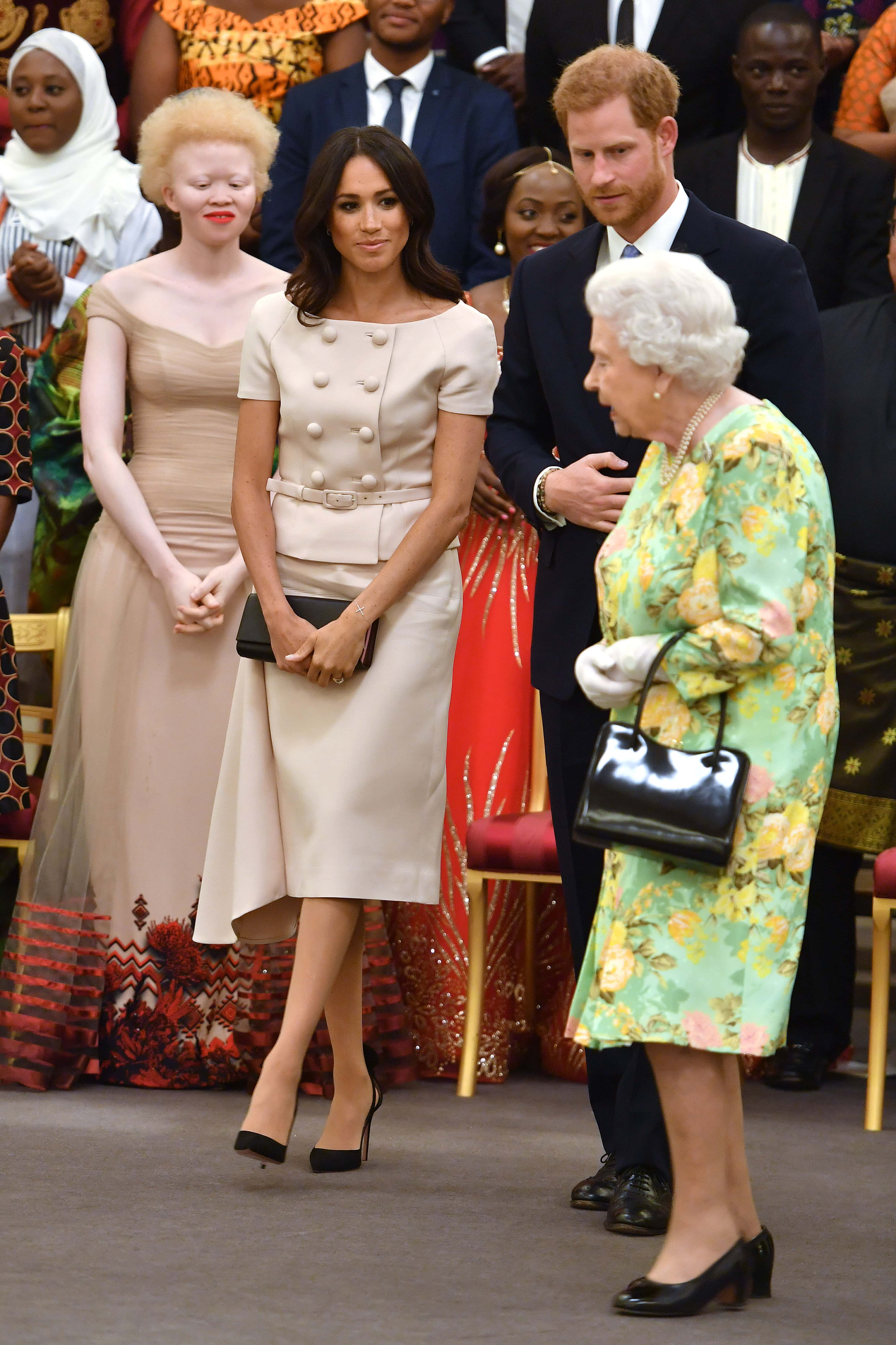 Meghan, Duchess of Sussex with Queen Elizabeth II and Prince Harry, Duke of Sussex at the Queen's Young Leaders Awards Ceremony at Buckingham Palace on June 26, 2018 in London, England. The Queen's Young Leaders Programme, now in its fourth and final year, celebrates the achievements of young people from across the Commonwealth working to improve the lives of people across a diverse range of issues including supporting people living with mental health problems, access to education, promoting gender equality, food scarcity and climate change.