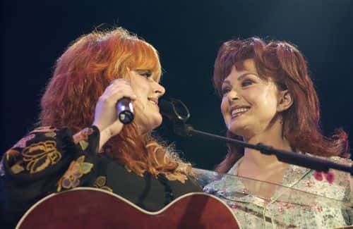 Wynonna (L) and Naomi Judd perform at the 32nd Annual Fan Fair country music festival on June 8, 2003 in Nashville, Tennessee.  The four-day festival, staged by the Country Music Association, is the largest of its kind and offers fans close access to many of country's biggest stars as well as nightly concerts featuring the genre's top performers.