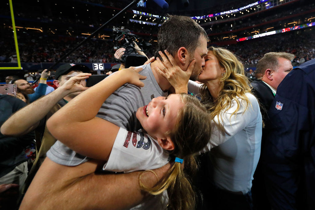 Tom Brady #12 of the New England Patriots kisses his wife Gisele Bündchen after Super Bowl LIII against the Los Angeles Rams at Mercedes-Benz Stadium on February 3, 2019, in Atlanta, Georgia. (Photo by Kevin C. Cox/Getty Images)