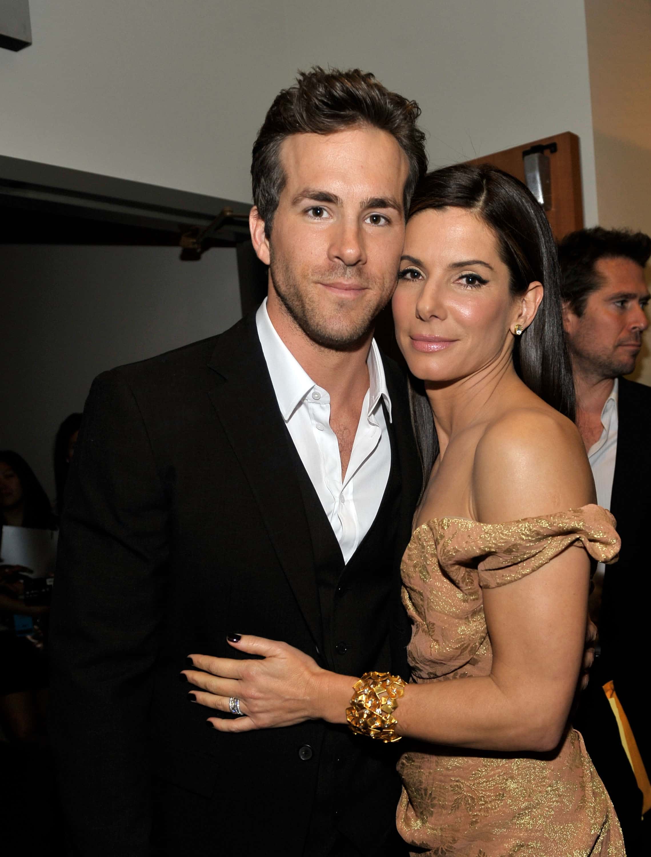 Actor Ryan Reynolds (L) and actress Sandra Bullock pose backstage during the People's Choice Awards 2010 held at Nokia Theatre L.A. Live on January 6, 2010 in Los Angeles, California.