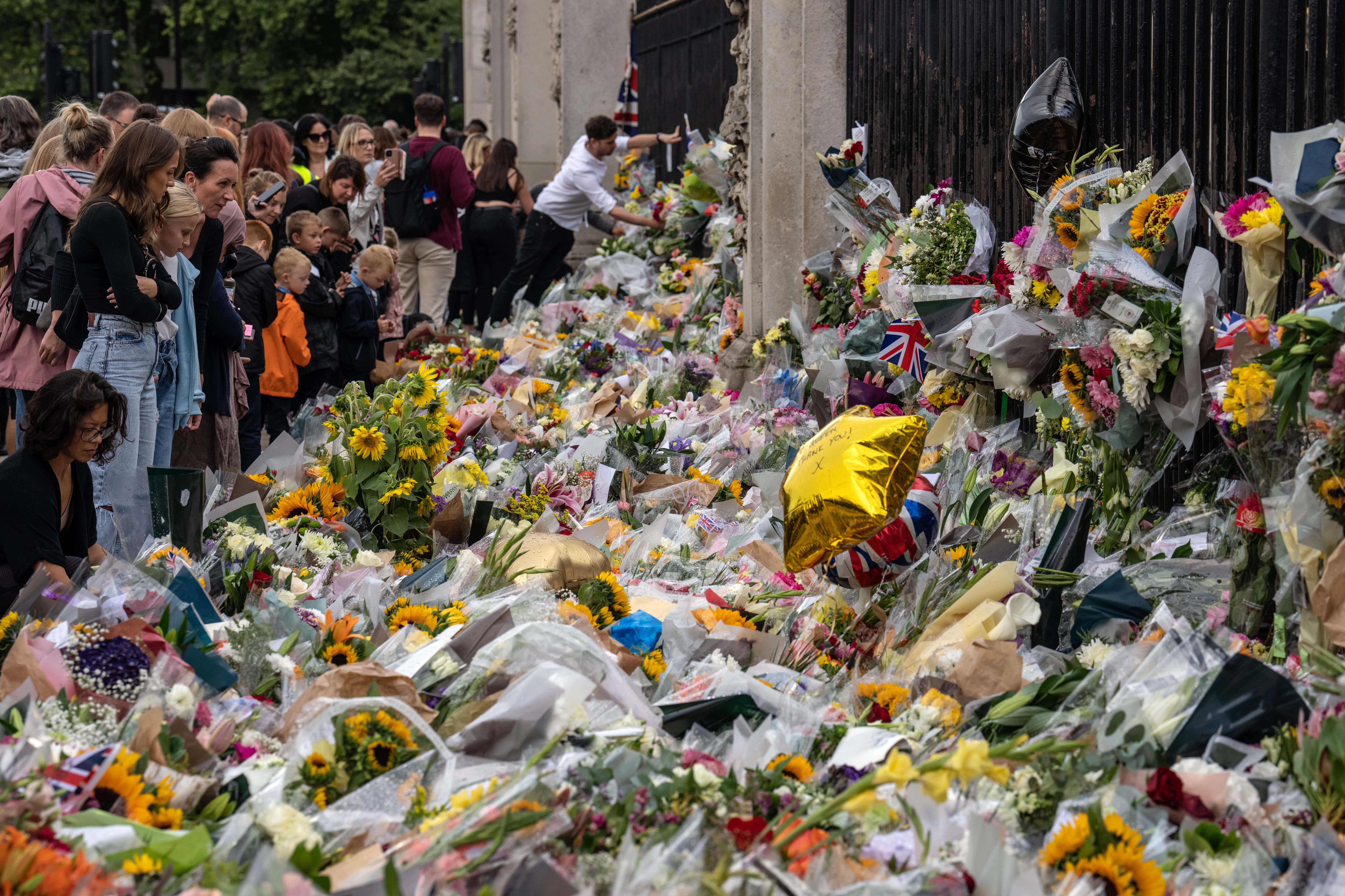 Flowers and tributes are laid outside Buckingham Palace on September 9, 2022 in London, United Kingdom. Elizabeth Alexandra Mary Windsor was born in Bruton Street, Mayfair, London on 21 April 1926. She married Prince Philip in 1947 and acceded the throne of the United Kingdom and Commonwealth on 6 February 1952 after the death of her Father, King George VI. Queen Elizabeth II died at Balmoral Castle in Scotland on September 8, 2022, and is succeeded by her eldest son, King Charles III.