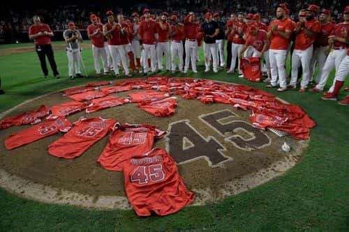 Los Angeles Angels of Anaheim players lay their jerseys on the pitchers mound after they won a combined no-hitter against the Seattle Mariners at Angel Stadium of Anaheim on July 12, 2019 in Anaheim, California. The entire Angels team wore Tyler Skaggs #45 jersey to honor him after his death on July 1. Angels won 13-0. Los Angeles Angels public relations employee Eric Kay is seen on left.