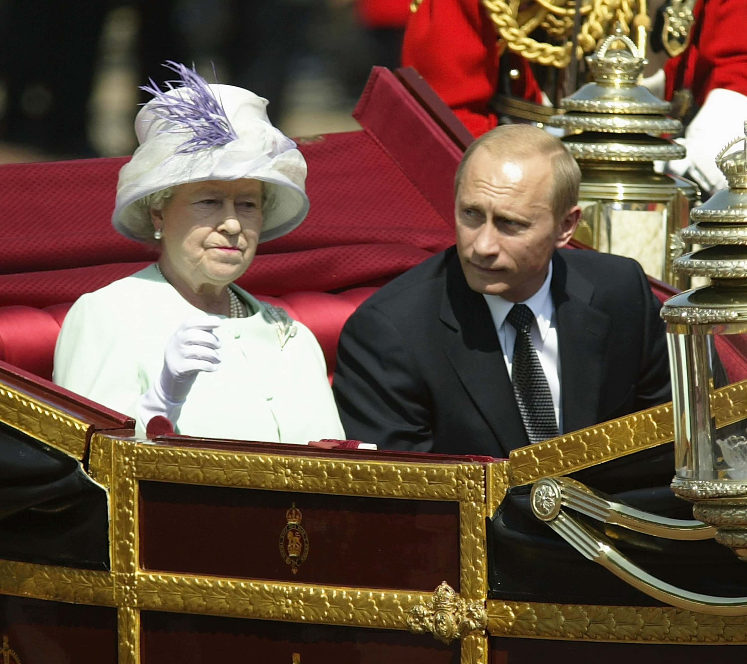 Russian President Vladimir Putin is accompanied by Her Majesty The Queen during a procession at The Mallat during the start iof his state visit on June 24, 2003 in London, England.  Putin is on a 4 days visit in Great Britain and will attend a number of functions during his time in the country.  The visit is the first by a Russian President since 1843.