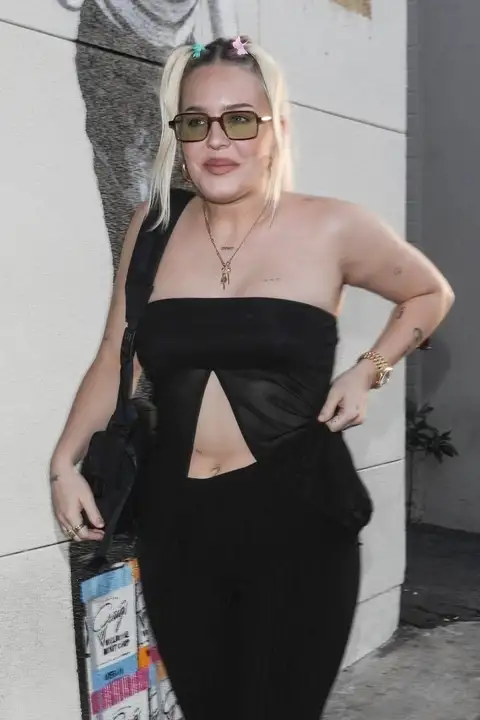 The singer, 31, donned a black strapless top with a sheer overlay that flashed a glimpse of her stomach (backgrid)