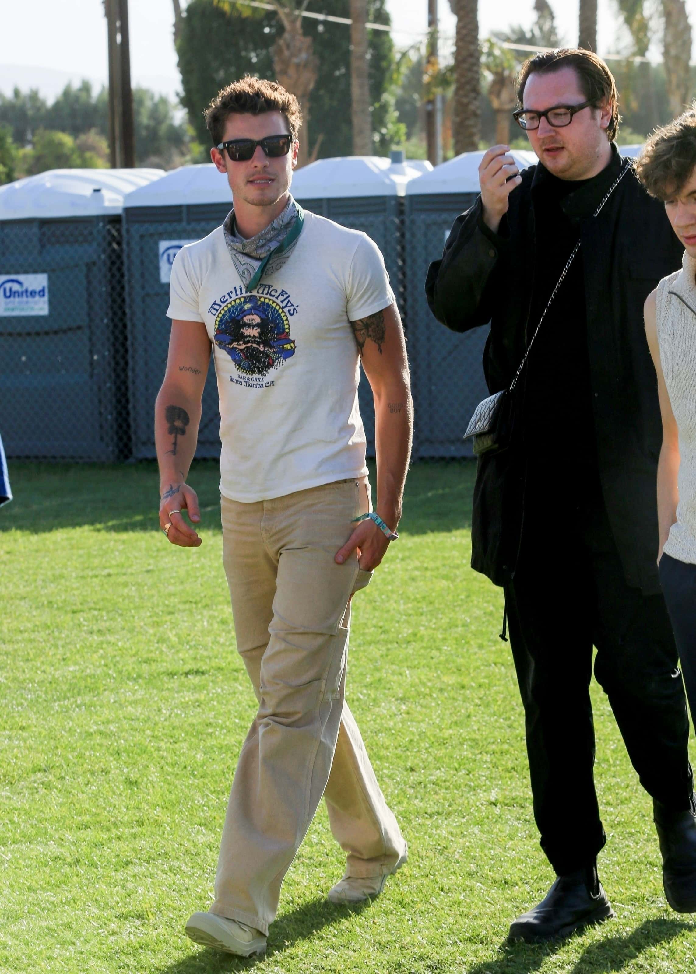 Shawn gave off a festival-friendly attire, sporting a fitting graphic tee, beige pants and a bandana (backgrid)