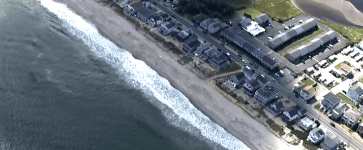 Gary Simard, 44, heard his son shouting 'help' during a family beach day and went into the dangerous waters to rescue his son (@cbsboston/Youtube)
