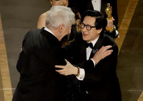 Ke Huy Quan (R) accepts the award for Best Picture for