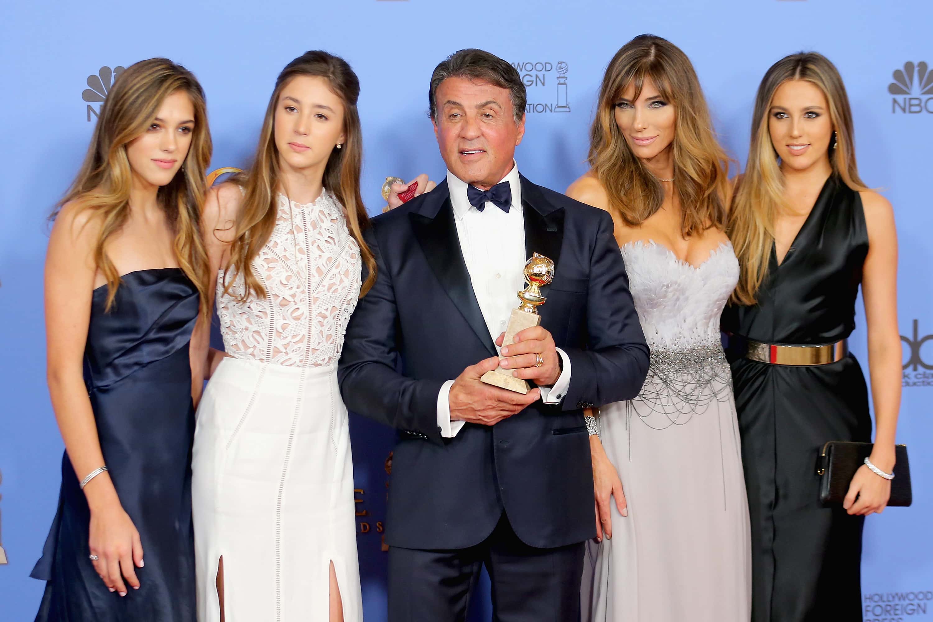 Actor Sylvester Stallone (C),  winner of Best Supporting Performance in a Motion Picture for 'Creed,' poses in the press room with wife Jennifer Flavin (2nd R) and daughters Sistine, Sophia and Scarlet during the 73rd Annual Golden Globe Awards held at the Beverly Hilton Hotel on January 10, 2016 in Beverly Hills, California.