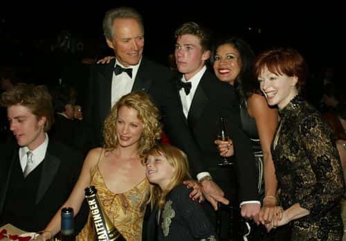 (U.S. TABS AND HOLLYWOOD REPORTER OUT)  Actor Clint Eastwood  and wife Dina Ruiz (R) pose with family and friends during the 9th Annual Screen Actors Guild Awards at the Shrine Auditorium on March 9, 2003 in Los Angeles, California. Eastwood was honored with the Lifetime Acheivement Award.