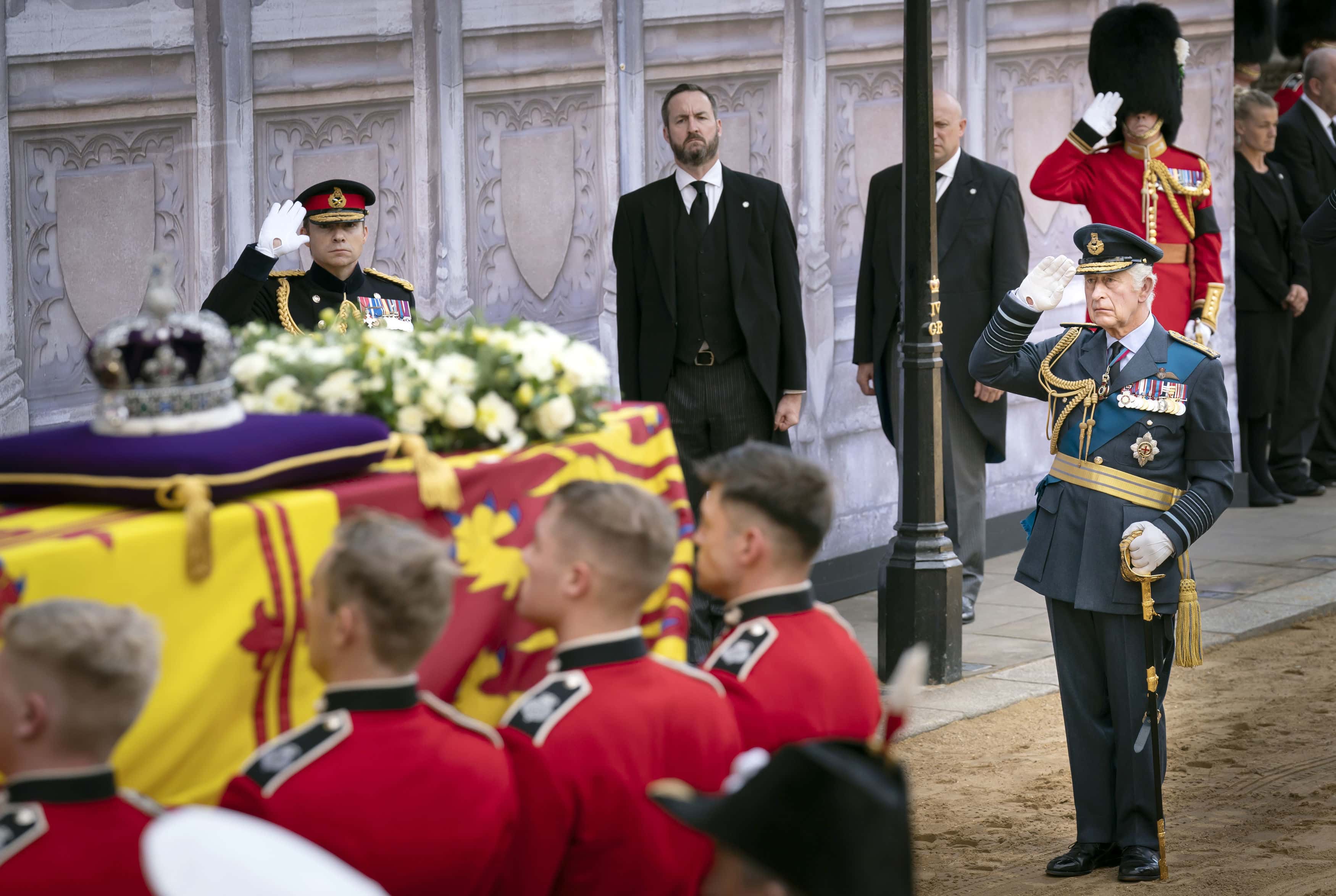 King Charles III, salutes as the bearer party carry the coffin of his mother, Queen Elizabeth II, into Westminster Hall, London, where it will lie in state ahead of her funeral on Monday, on September 14, 2022 in London, England. Queen Elizabeth II's coffin is taken in procession on a Gun Carriage of The King's Troop Royal Horse Artillery from Buckingham Palace to Westminster Hall where she will lay in state until the early morning of her funeral. Queen Elizabeth II died at Balmoral Castle in Scotland on September 8, 2022, and is succeeded by her eldest son, King Charles III.
