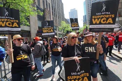 Writers Guild of America (WGA) East members participate in a “Rally at the Rock” strike event outside of the NBCUniversal offices on May 23, 2023 in New York City. On the fourth week of the of the Hollywood writers strike WGA East members were joined by prominent writers, labor leaders, elected officials, and members of various unions as they held a rally at 30 Rock.