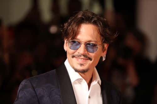 Johnny Depp walks the red carpet ahead of the