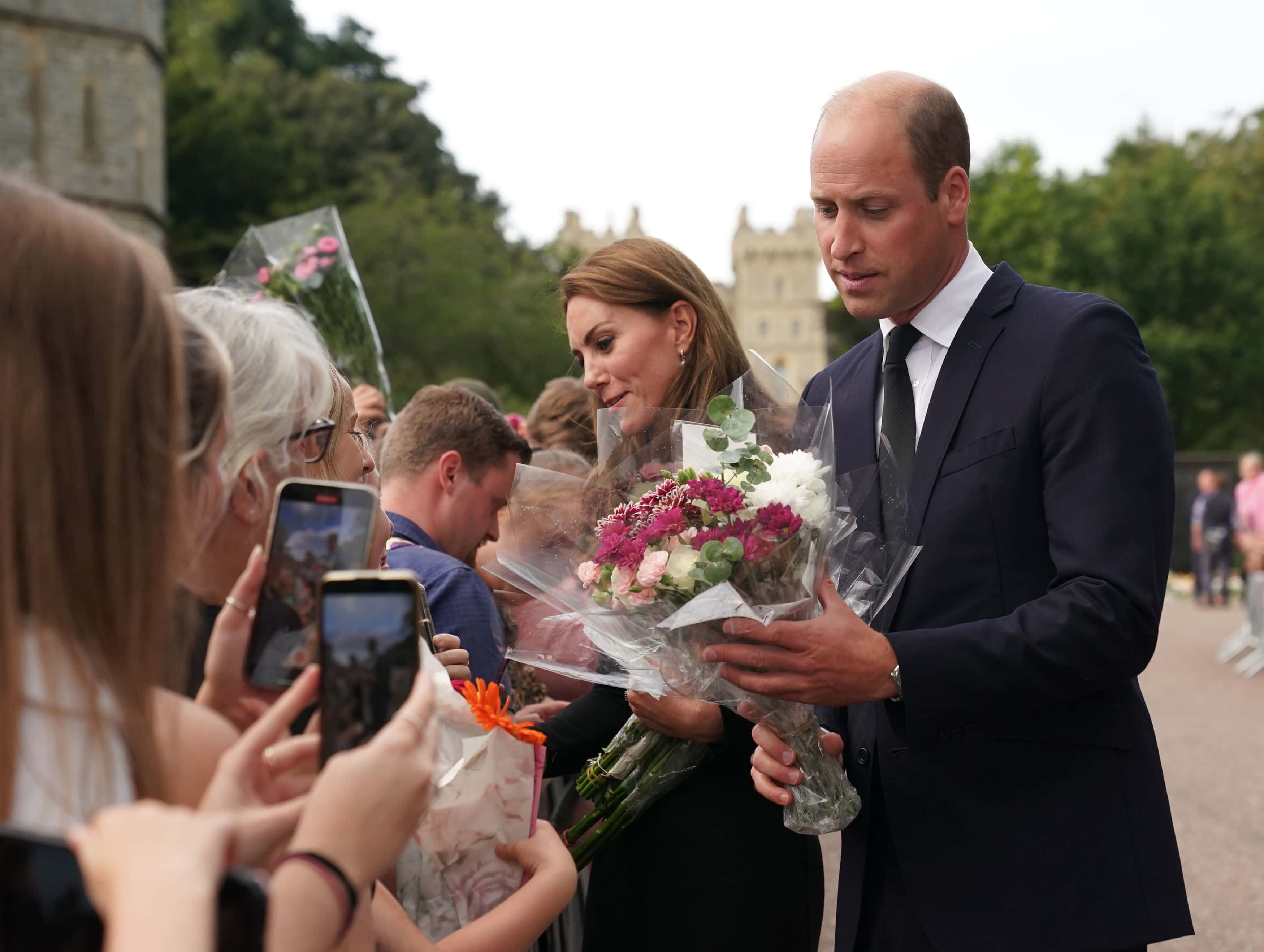 Catherine, Princess of Wales and Prince William, Prince of Wales meet members of the public at Windsor Castle on September 10, 2022 in Windsor, England. Crowds have gathered and tributes left at the gates of Windsor Castle to Queen Elizabeth II, who died at Balmoral Castle on 8 September, 2022.