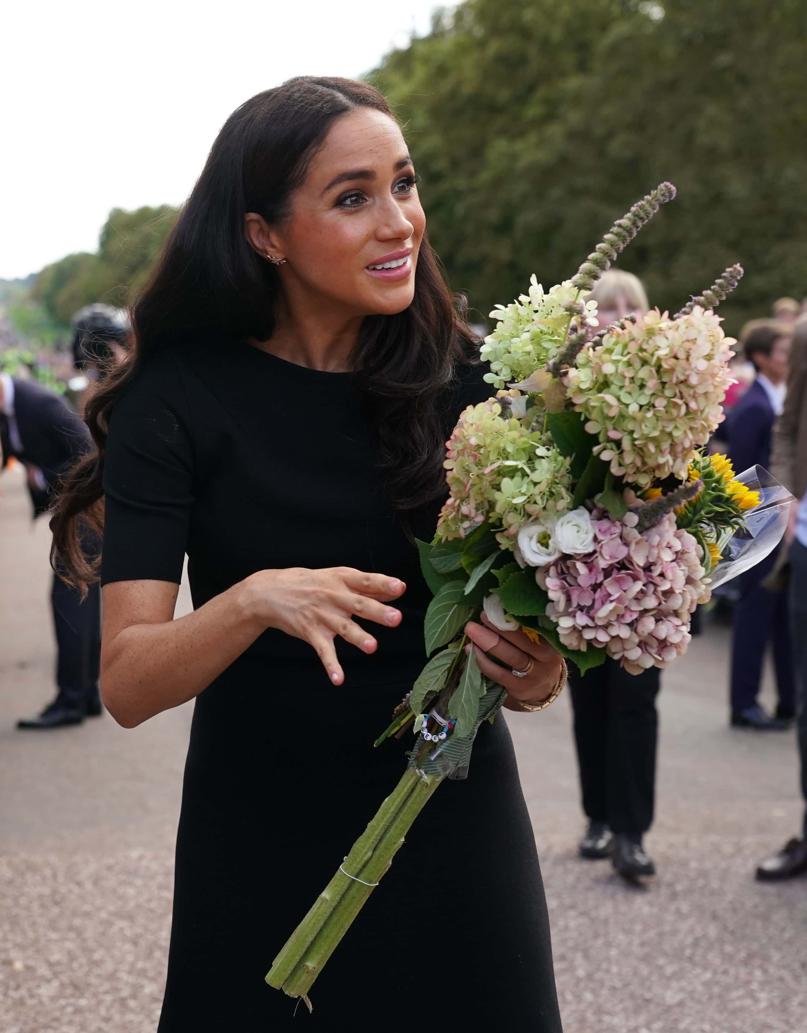 Meghan, Duchess of Sussex meet members of the public at Windsor Castle on September 10, 2022 in Windsor, England. Crowds have gathered and tributes left at the gates of Windsor Castle to Queen Elizabeth II, who died at Balmoral Castle on 8 September, 2022.