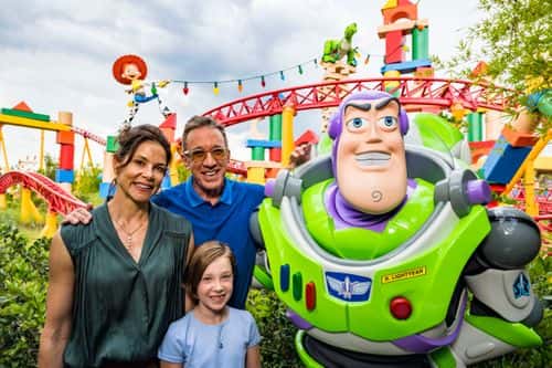 In this handout image provided by Walt Disney World Resort,actor Tim Allen, his wife Jane and daughter Elizabeth pose with Buzz Lightyear during a special preview of Toy Story Land at Disney's Hollywood Studios on Wednesday, June 27, 2018 in Lake Buena Vista, Florida. In the new land, officially open on June 30, Walt Disney World Resort guests can whoosh along on the family-friendly roller coaster Slinky Dog Dash, take a spin aboard Alien Swirling Saucers and try for the high score on Toy Story Mania!