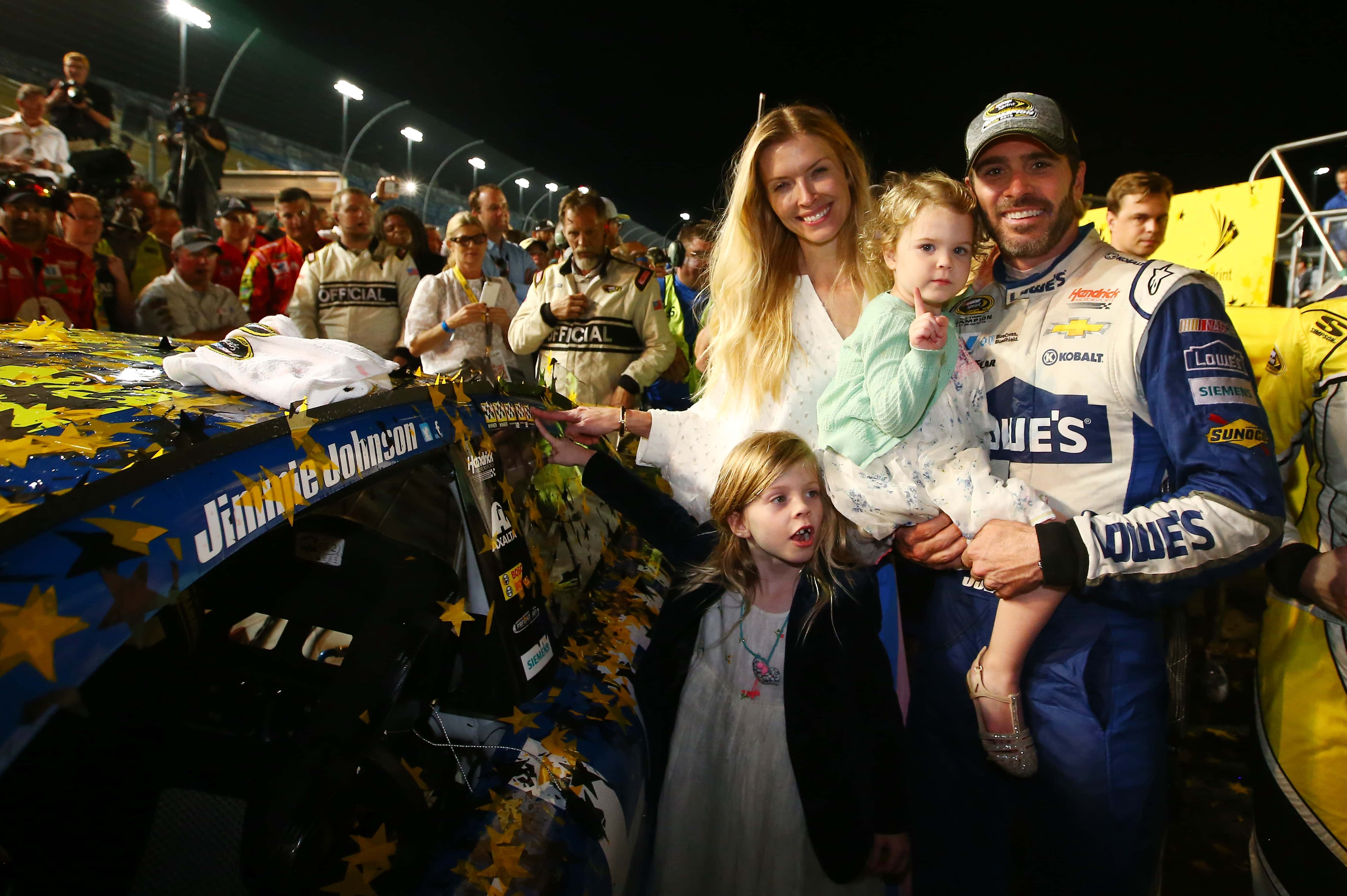 HOMESTEAD, FL - NOVEMBER 20: Jimmie Johnson, driver of the #48 Lowe's Chevrolet, poses in Victory Lane with his wife Chandra and daughters Genevieve Marie and Lydia Norriss after winning the NASCAR Sprint Cup Series Ford EcoBoost 400 and the 2016 NASCAR Sprint Cup Series Championship at Homestead-Miami Speedway on November 20, 2016 in Homestead, Florida. Johnson wins a record-tying 7th NASCAR title. (Photo by Sarah Crabill/Getty Images)

