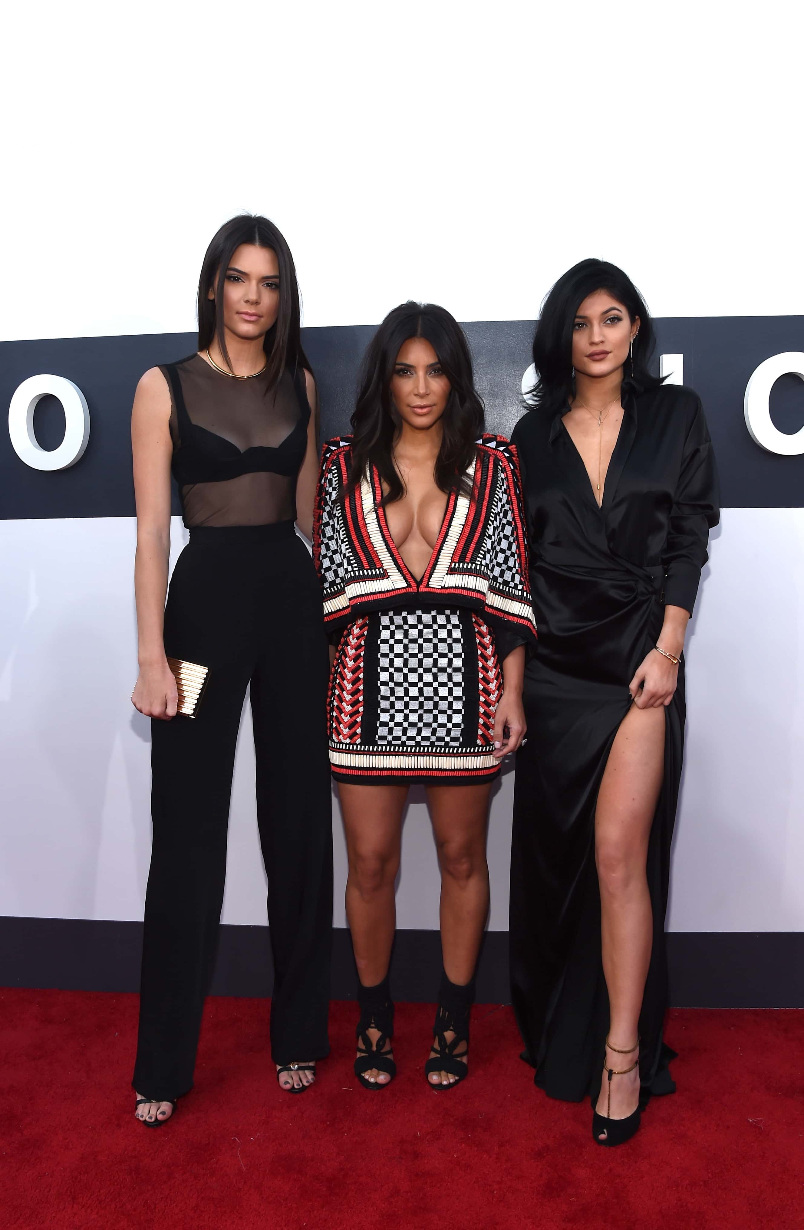 (L-R) TV personalities Kendall Jenner, Kim Kardashian, and Kylie Jenner attend the 2014 MTV Video Music Awards at The Forum on August 24, 2014, in Inglewood, California. (Photo by Larry Busacca/Getty Images for MTV)