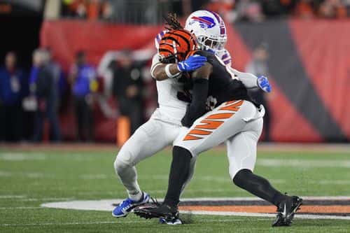 Damar Hamlin #3 of the Buffalo Bills tackles Tee Higgins #85 of the Cincinnati Bengals during the first quarter at Paycor Stadium on January 02, 2023 in Cincinnati, Ohio. Hamlin was taken off the field by medical personnel following the play.