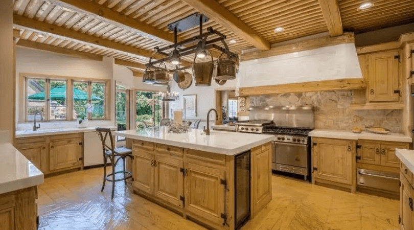 The kitchen has exposed wooden ceiling beams and hand-painted tiles, and there is even an attached apartment (Realtor.com)
