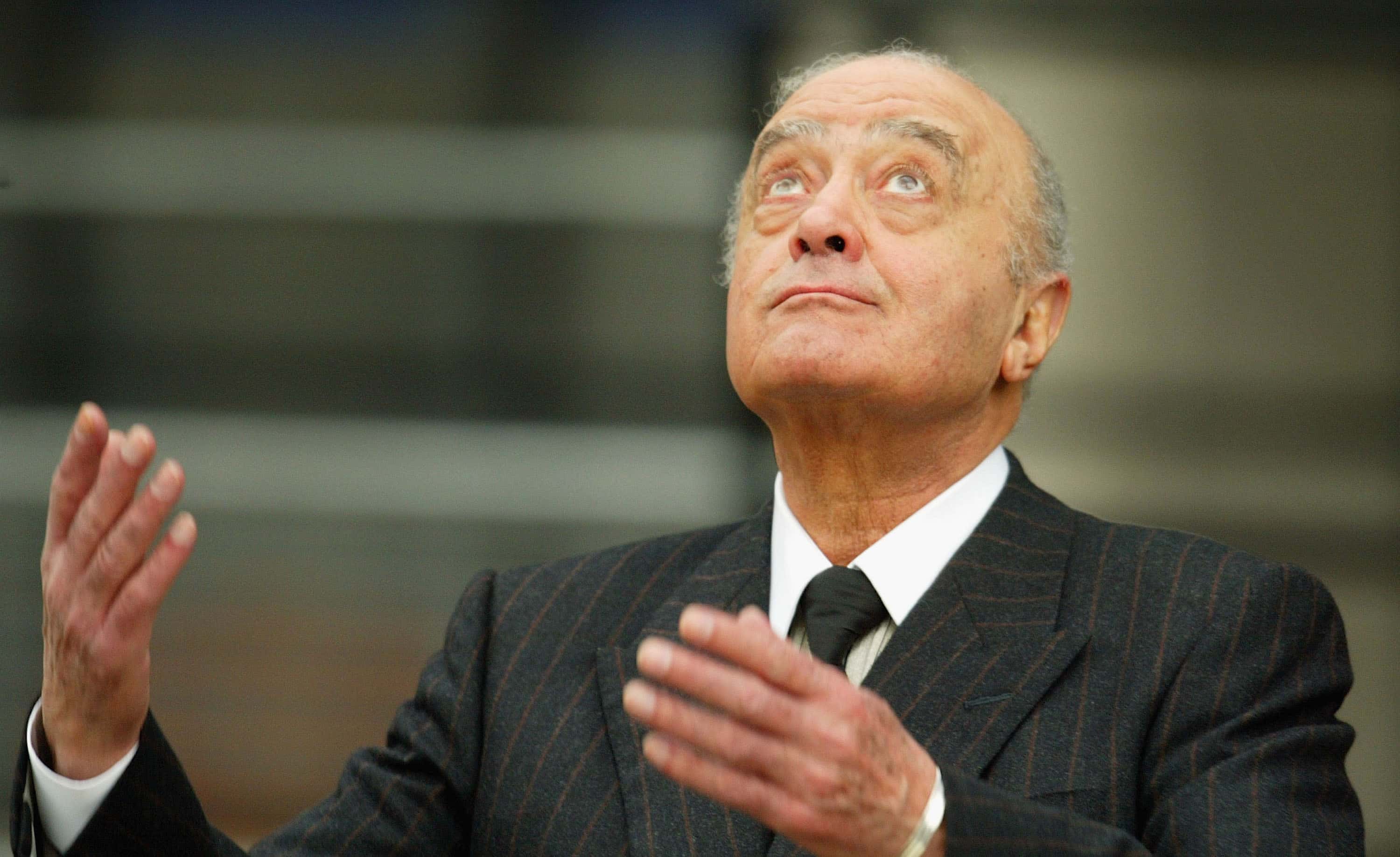 LONDON - JANUARY 06: Mohamed Al Fayed gestures as he leaves after attending the opening of the inque