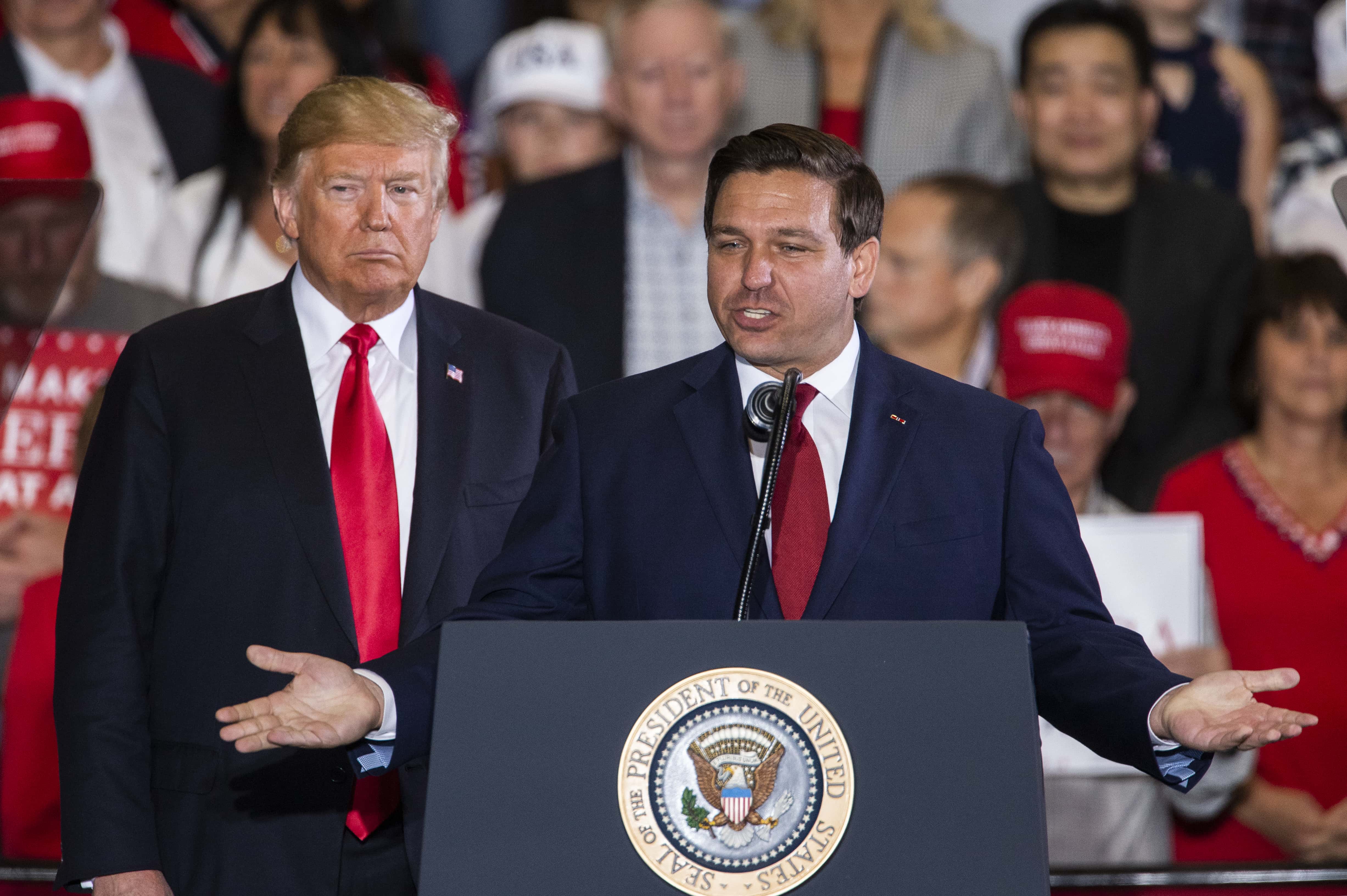 PENSACOLA, FL - NOVEMBER 03: Florida Republican gubernatorial candidate Ron DeSantis speaks with U.S. President Donald Trump at a campaign rally at the Pensacola International Airport on November 3, 2018 in Pensacola, Florida. President Trump is campaigning in support of Republican candidates in the upcoming midterm elections. (Photo by Mark Wallheiser/Getty Images)
