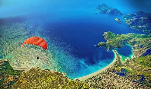 Paraglider flying at Fethiye over Blue lagoon in Oludeniz, Turkey (Getty Images)