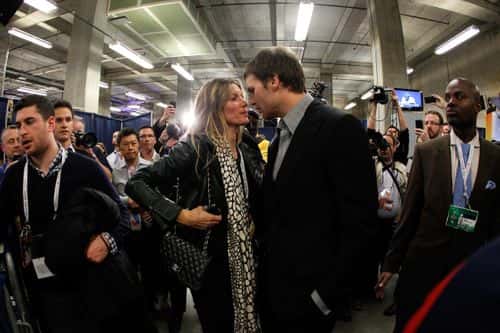Tom Brady #12 of the New England Patriots chats with his wife Gisele Bundchen speak in the press conference area after the Patriots lost 21-17 against the New York Giants during Super Bowl XLVI at Lucas Oil Stadium on February 5, 2012 in Indianapolis, Indiana.