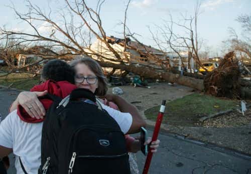 A residents embrace while evacuating their neighborhood after a large tornado damaged hundreds of homes and buildings on March 31, 2023 in Little Rock, Arkansas. Tornados damaged hundreds of homes and buildings Friday afternoon across a large part of Central Arkansas. Governor Sarah Huckabee Sanders declared a state of emergency after the catastrophic storms that hit on Friday afternoon. According to local reports, the storms killed at least three people.