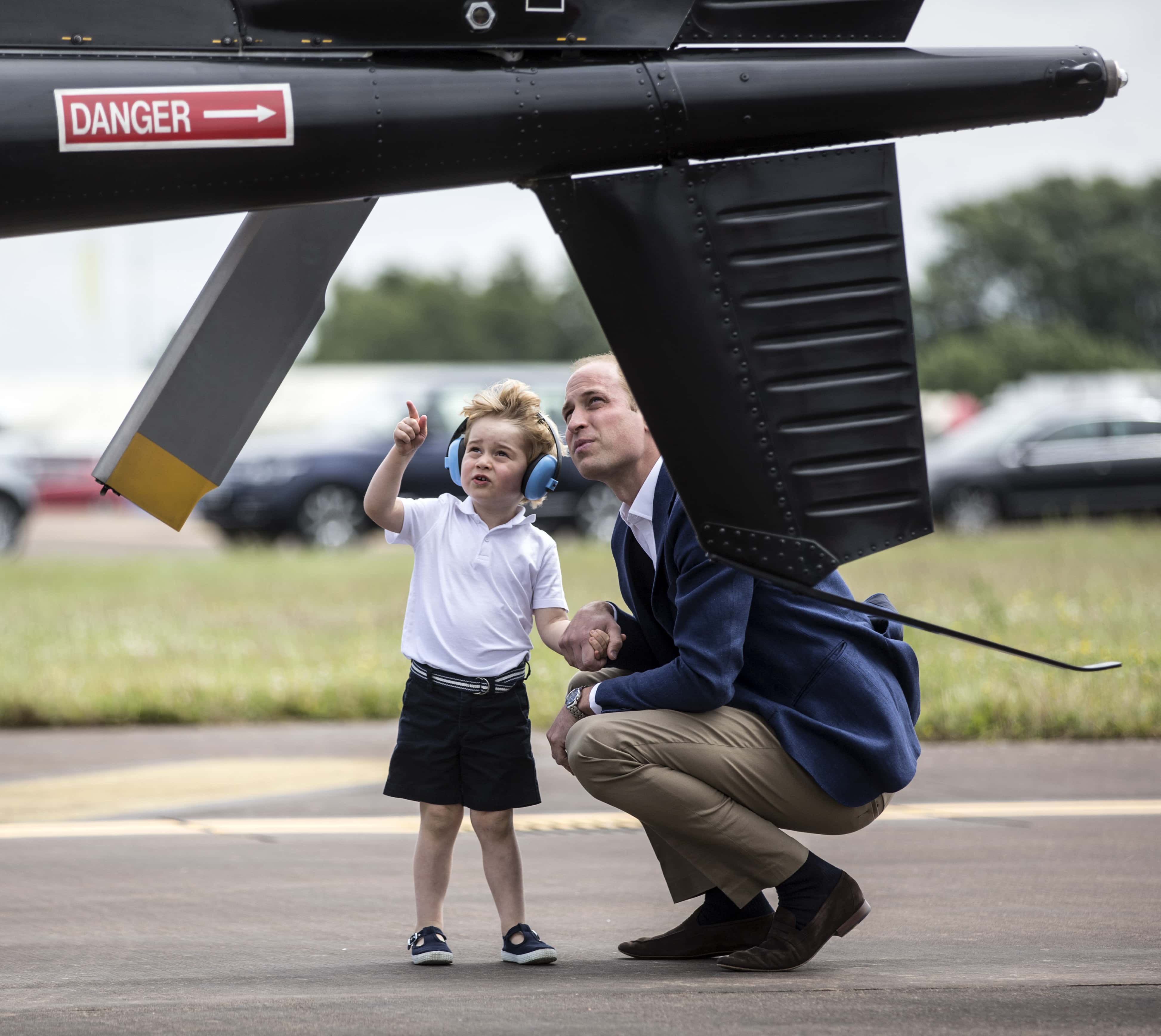Prince George points up at the tail rotor of a