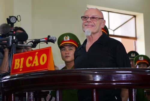 Former British glam rocker Gary Glitter listens to a guilty verdict being read out at the People's Courthouse March 3, 2006 in Ba Ria, Vietnam. Glitter, 61, received three years in prison for commiting obscene acts with two underaged girls in Vietnam.