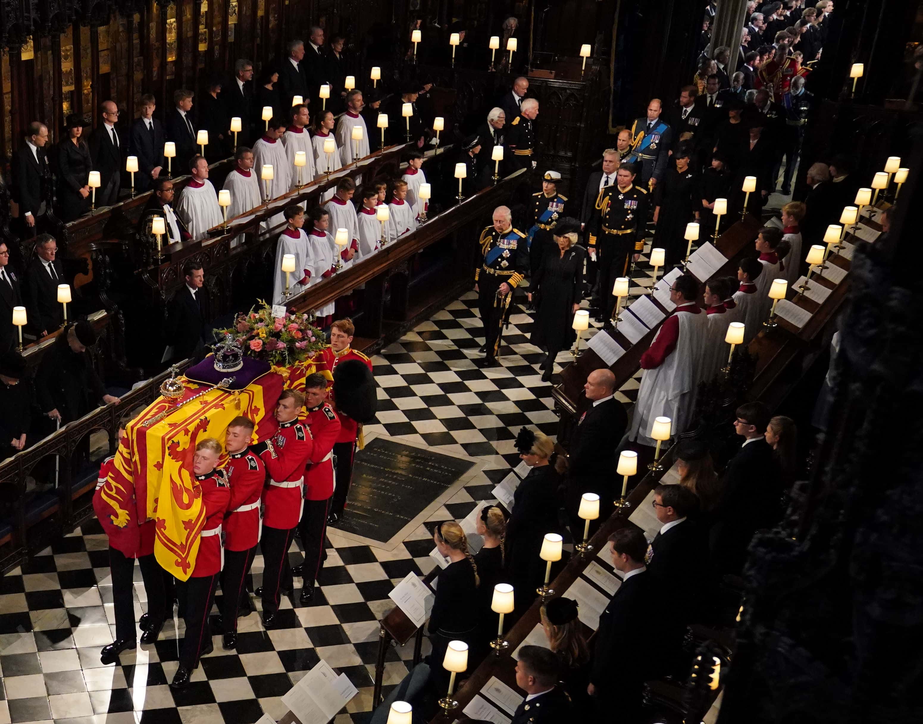 The coffin of Queen Elizabeth II, followed by (left to right, from front) King Charles III, the Queen Consort, the Princess Royal, Vice Admiral Sir Tim Laurence, the Duke of York, the Earl of Wessex, the Countess of Wessex, the Prince of Wales, Prince George, Princess Charlotte, the Princess of Wales, the Duke of Sussex, the Duchess of Sussex, Peter Phillips, the Earl of Snowdon, the Duke of Gloucester, the Duke of Kent, and Prince Michael of Kent,  is carried by the Bearer Party in to the Committal Service at St George's Chapel in Windsor Castle on September 19, 2022 in Windsor, England. The committal service at St George's Chapel, Windsor Castle, took place following the state funeral at Westminster Abbey. A private burial in The King George VI Memorial Chapel followed. Queen Elizabeth II died at Balmoral Castle in Scotland on September 8, 2022, and is succeeded by her eldest son, King Charles III.