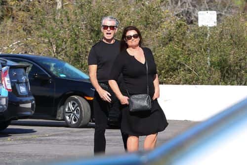 The James Bond actor, 69, and his wife of 21 years rocked all-black ensembles for the sunny excursion in the seaside town. (Backgrid)