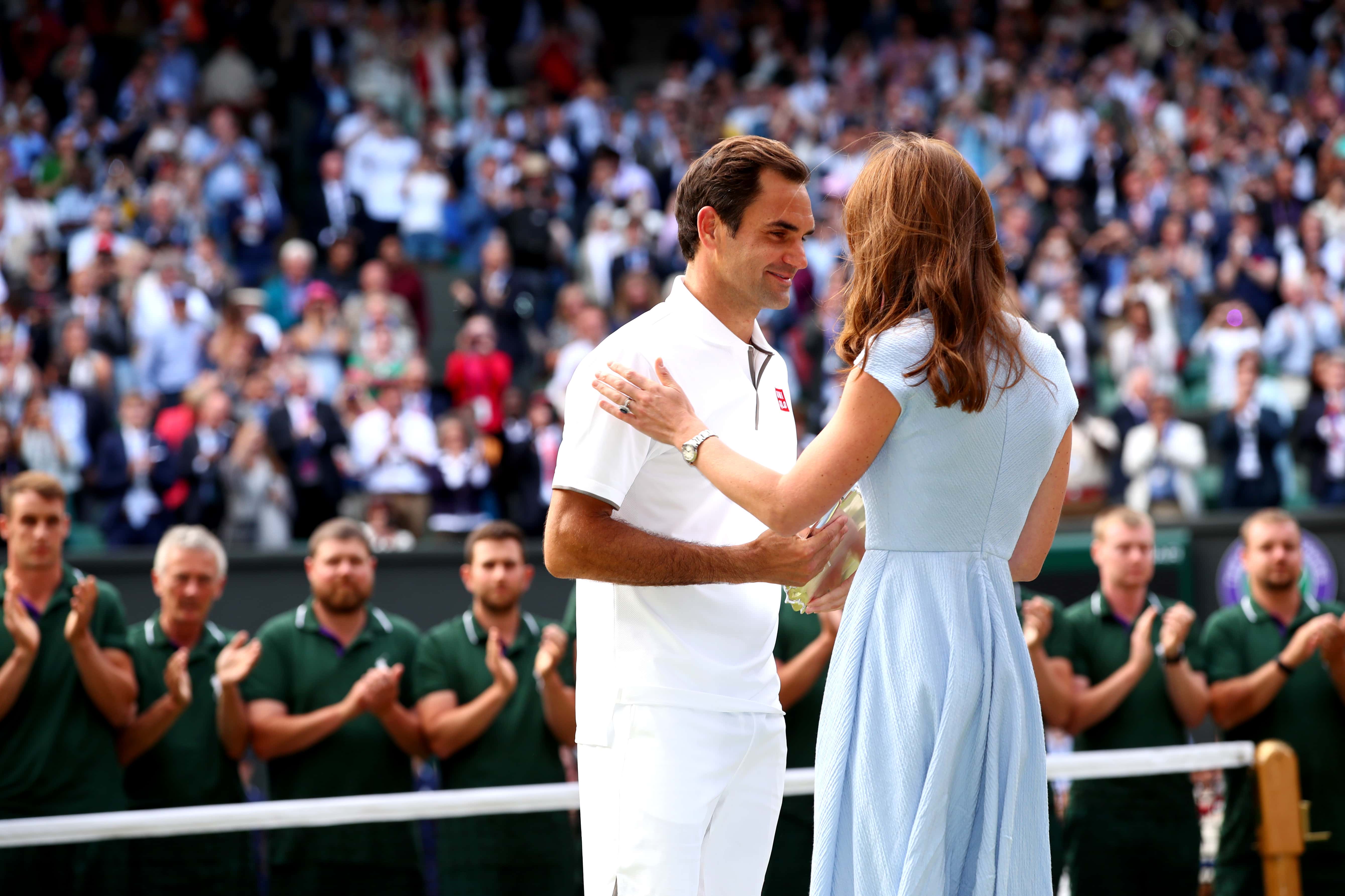 Roger Federer of Switzerland is presented with the runners-up trophy by Catherine Duchess of Cambridge after his Men's Singles final against Novak Djokovic of Serbia during Day thirteen of The Championships - Wimbledon 2019 at All England Lawn Tennis and Croquet Club on July 14, 2019 in London, England. (Photo by Clive Brunskill/Getty Images)