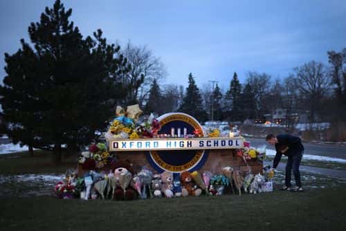 People visit a makeshift memorial outside of Oxford High School on December 01, 2021 in Oxford, Michigan.  Yesterday, four students were killed and seven injured when student Ethan Crumbley allegedly opened fire on fellow students at the school.