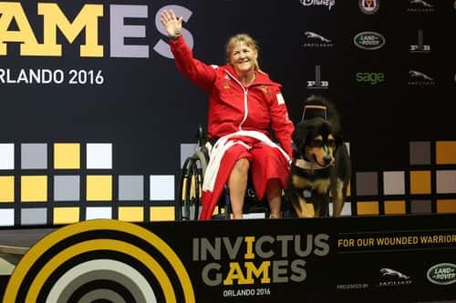 Christine Gauthier waves as she receives the Gold Medal in Women's Heavyweight powerlifting finals at the Invictus Games on May 9, 2016 in Lake Buena Vista, Florida.