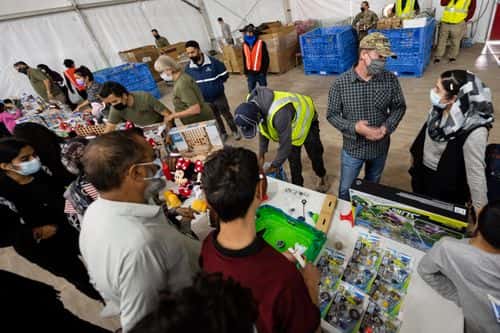 Save Our Allies workers hand out toys in a supply tent in an Afghan refugee camp on November 4, 2021 in Holloman Air Force Base, New Mexico. The Department of Defense and US Department of Homeland Security's initiative, Operation Allies Welcome, aims to support and house Afghan refugees as they transition into more permanent housing in the US.