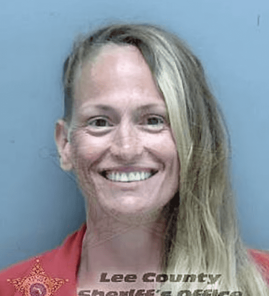 Daugherty, 41, is shown grinning in her mug shot on Monday after being charged with child neglect (Lee County Sherrif's Office)