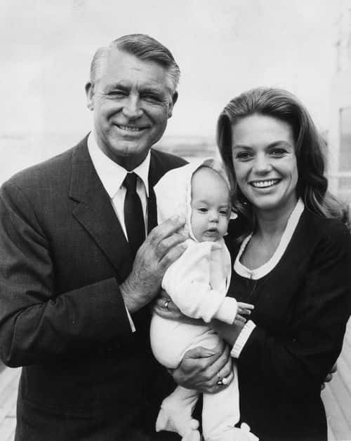 Film star Cary Grant (1904 - 1986) with his fourth wife Dyan Cannon and their baby daughter Jennifer on a visit to England.