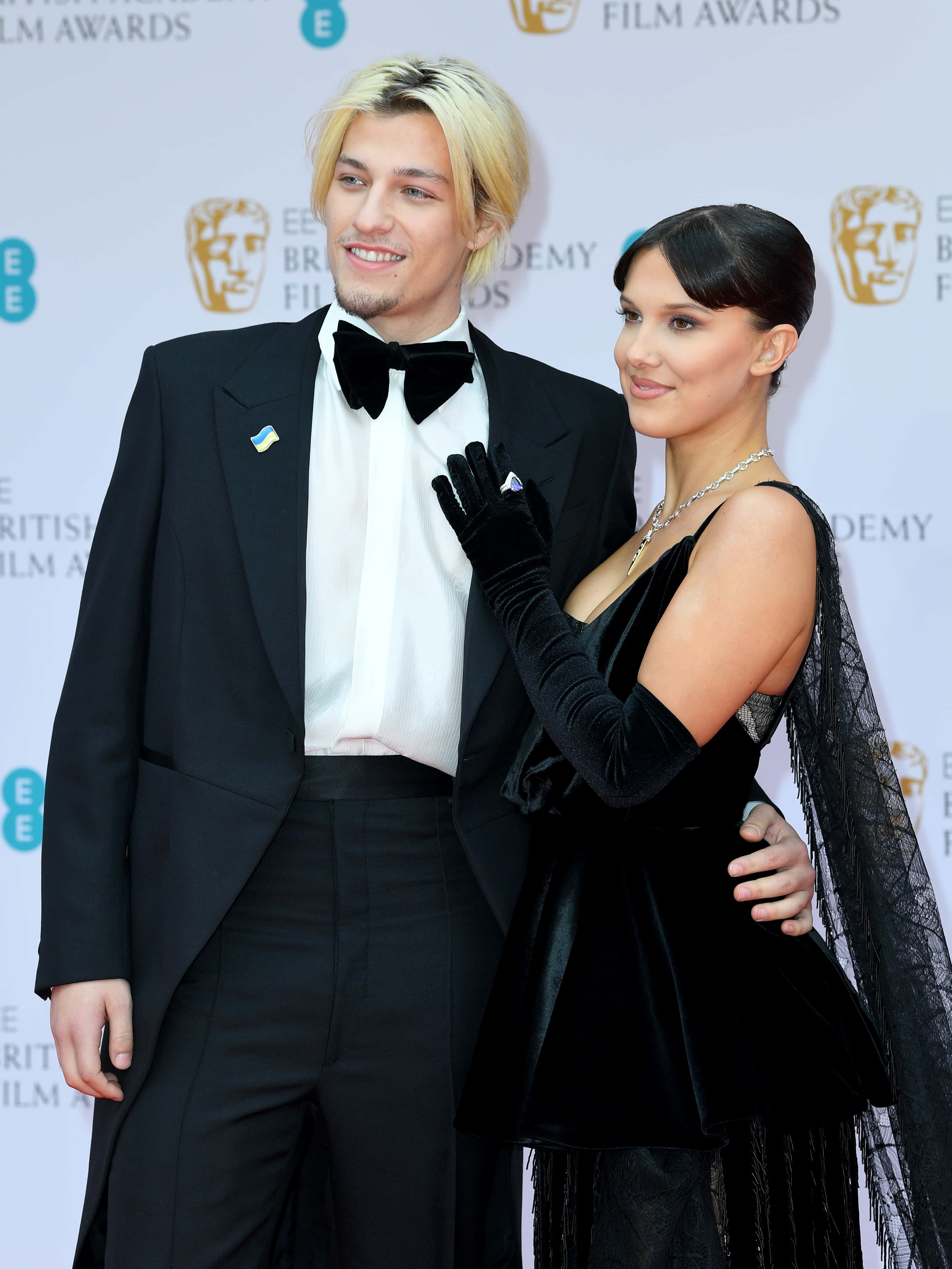 Jake Bongiovi and Millie Bobby Brown attend the EE British Academy Film Awards 2022 at Royal Albert Hall on March 13, 2022 in London, England.