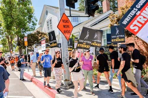 SAG-AFTRA and WGA members walk the picket line on Day 1 outside Culver Studios, home of Amazon Studios, on July 13, 2023 in Los Angeles, California. Members of SAG-AFTRA, Hollywood’s largest union which represents actors and other media professionals, have joined striking WGA (Writers Guild of America) workers in the first joint walkout against the studios since 1960. The strike could shut down Hollywood productions completely with writers in the third month of their strike against the Hollywood studios. on July 13, 2023 in Los Angeles, California.