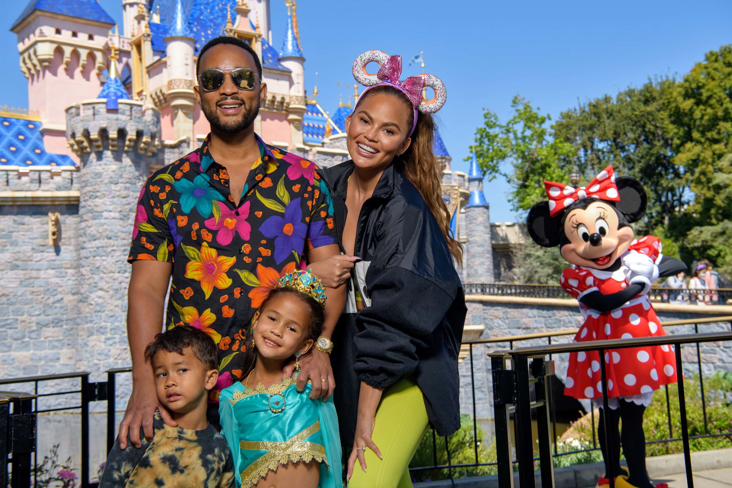 In this handout photo provided by Disneyland Resort, John Legend, Chrissy Teigen and their children, Miles and Luna pose with Minnie Mouse while celebrating Luna’s birthday at Disneyland on April 14, 2022 in Anaheim, California.